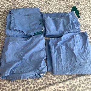 4 pairs of lightly used OR scrubs. Each set includes top & bottom, size Medium